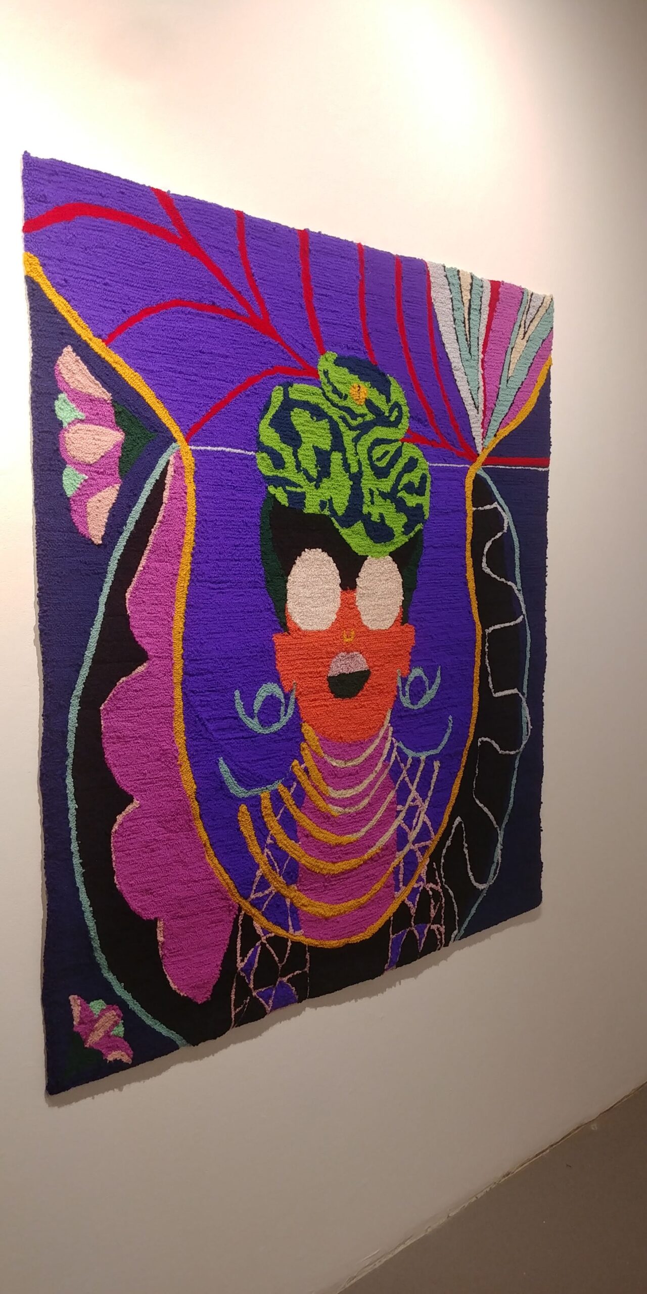 finished wall hanging woman with head scarf and glasses