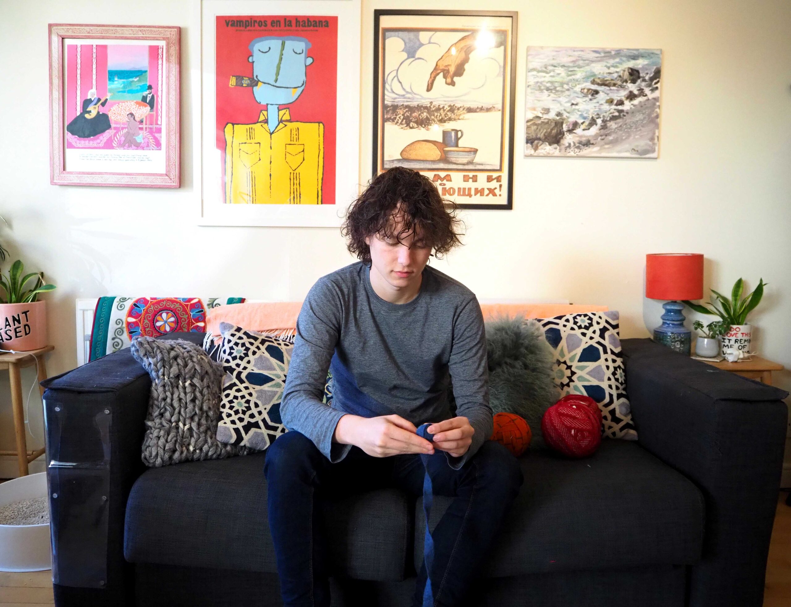 christian on sofa balling blanket yarn