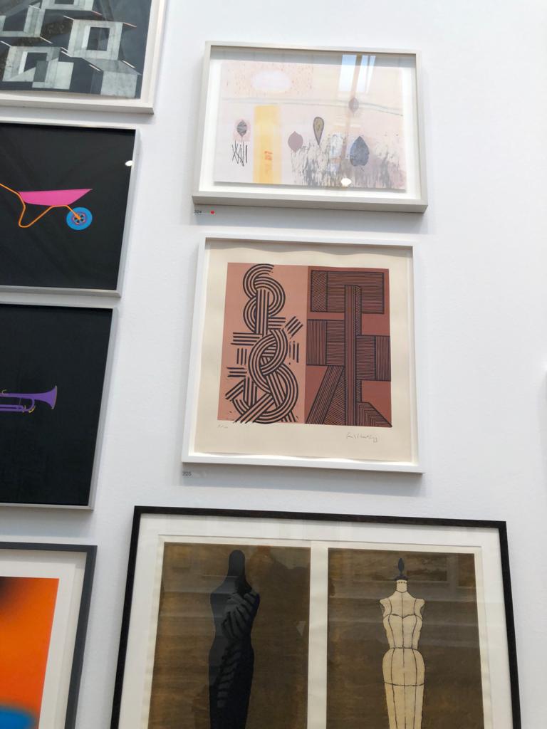 small framed artwork hung on white wall art exhibition