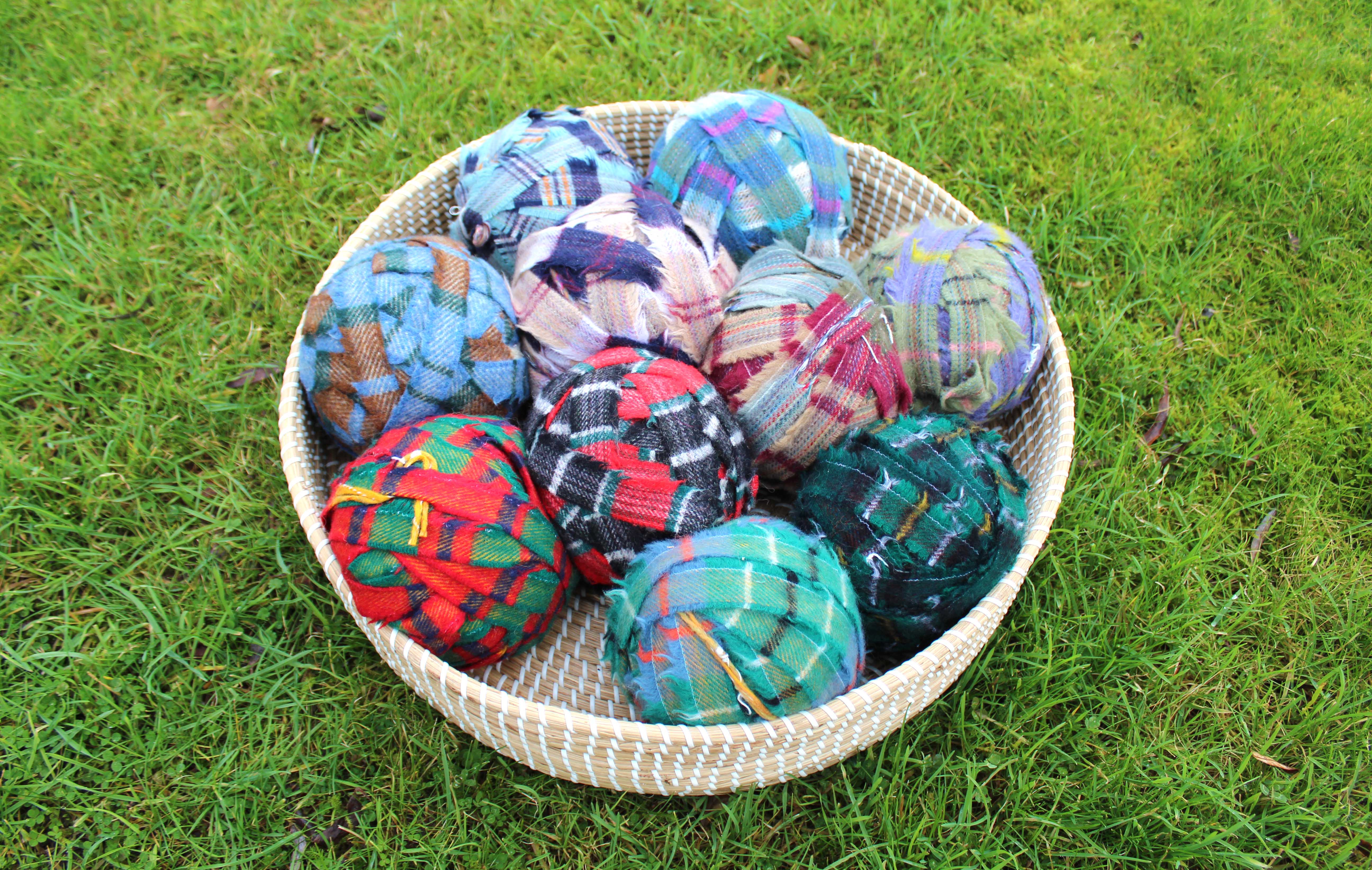 basket of large mixed balls of tartan blanket yarn