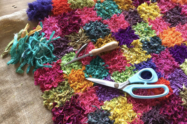 Work in progress rag rug with spring tool and scissors