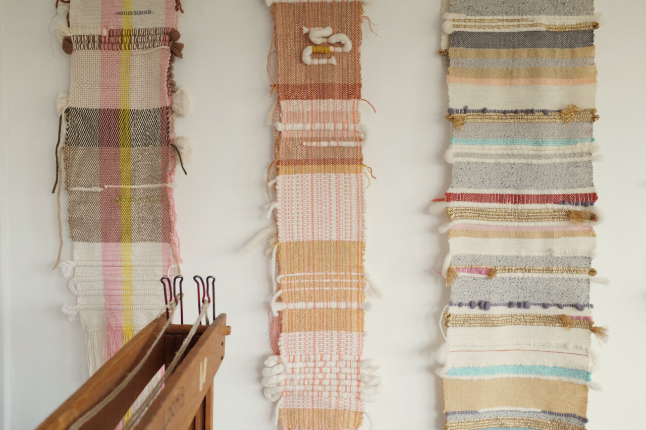 Lucy Rowan's woven tapestries hanging on a wall