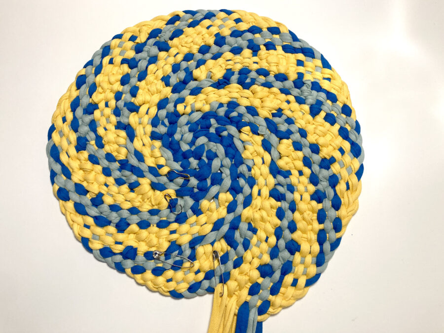 Yellow and blue circular plaited rag rug